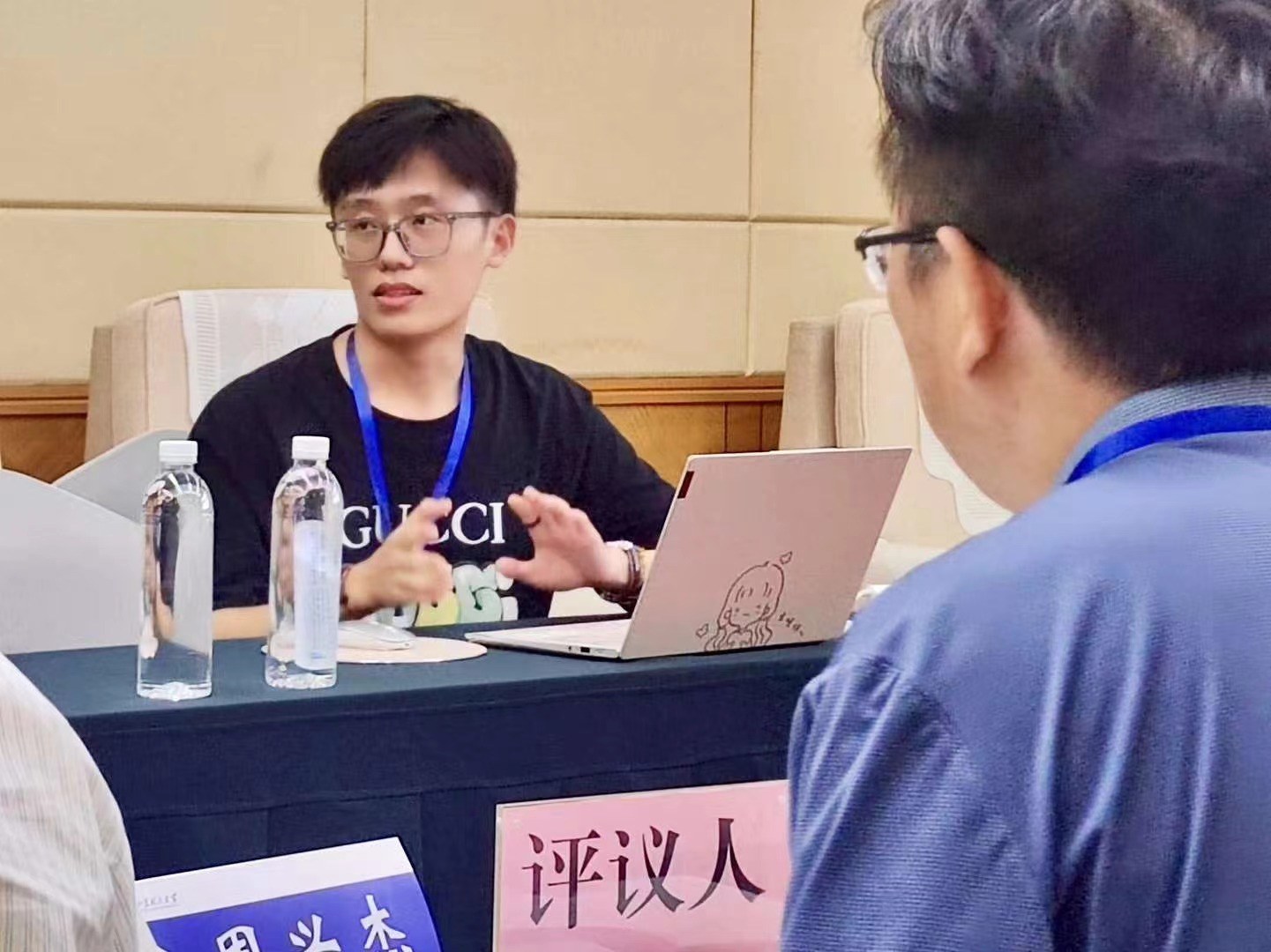 A presenter in discussion with fellow conference participants.